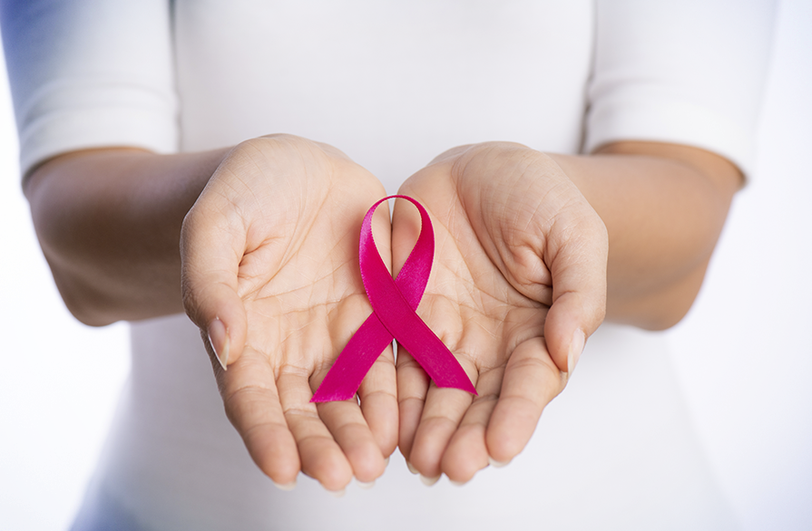 Mãos com laço de Outubro Rosa